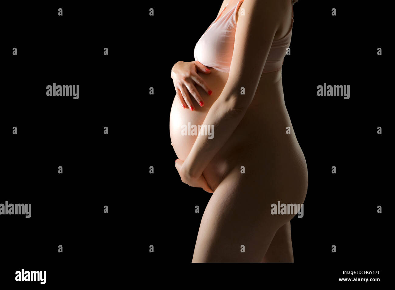 Pregnant woman is holding her belly Stock Photo