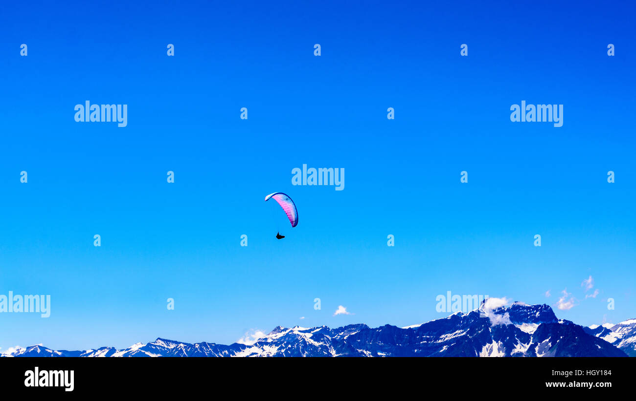 Paragliders soaring high over the alps in Verbier, Switzerland in the summer. Stock Photo