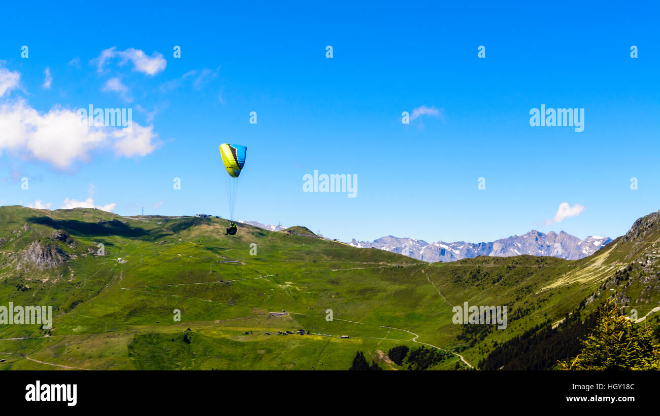 Paragliders soaring high over the alps in Verbier, Switzerland in the summer. Stock Photo