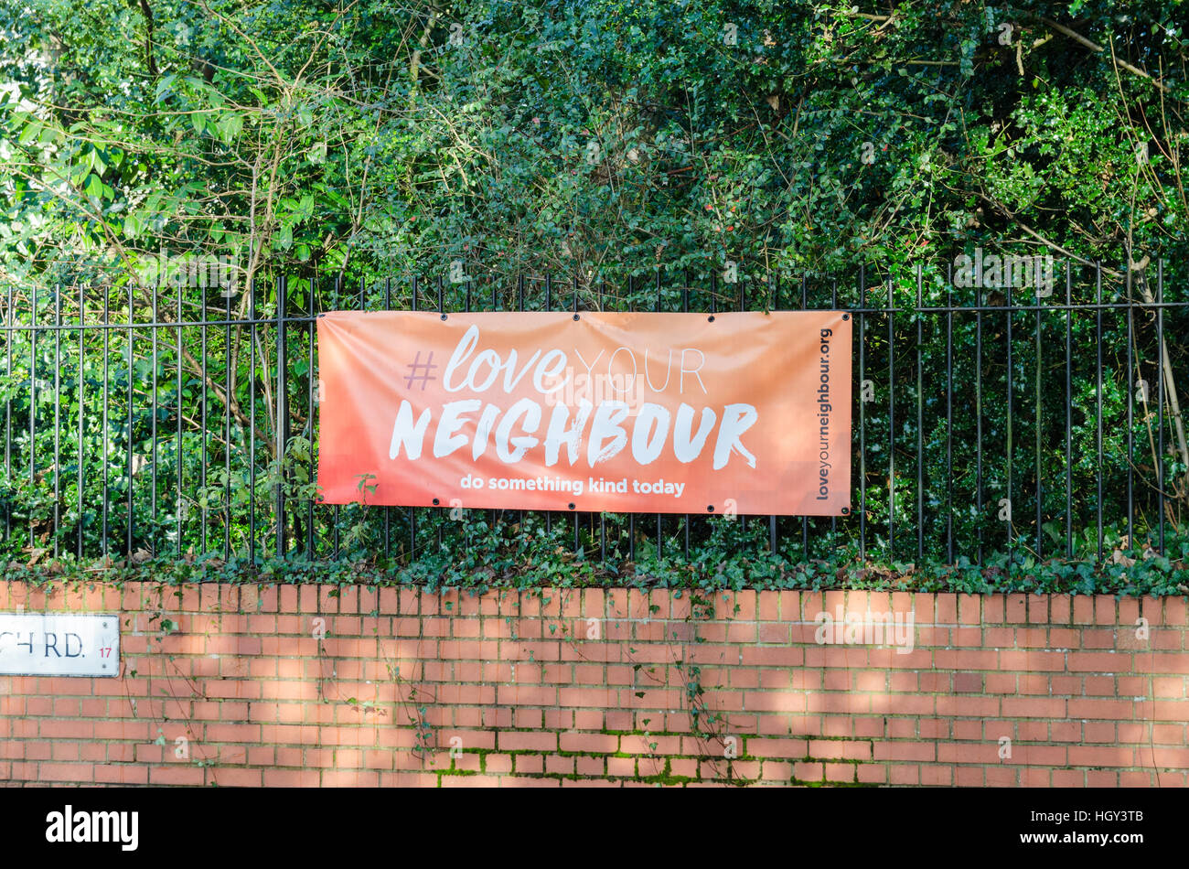 Love your neighbour banner hires stock