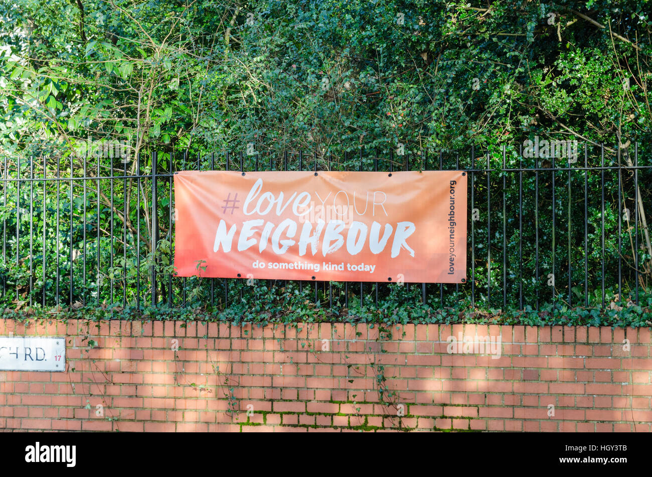 Banner outside church saying 'Love Your Neighbour' Stock Photo