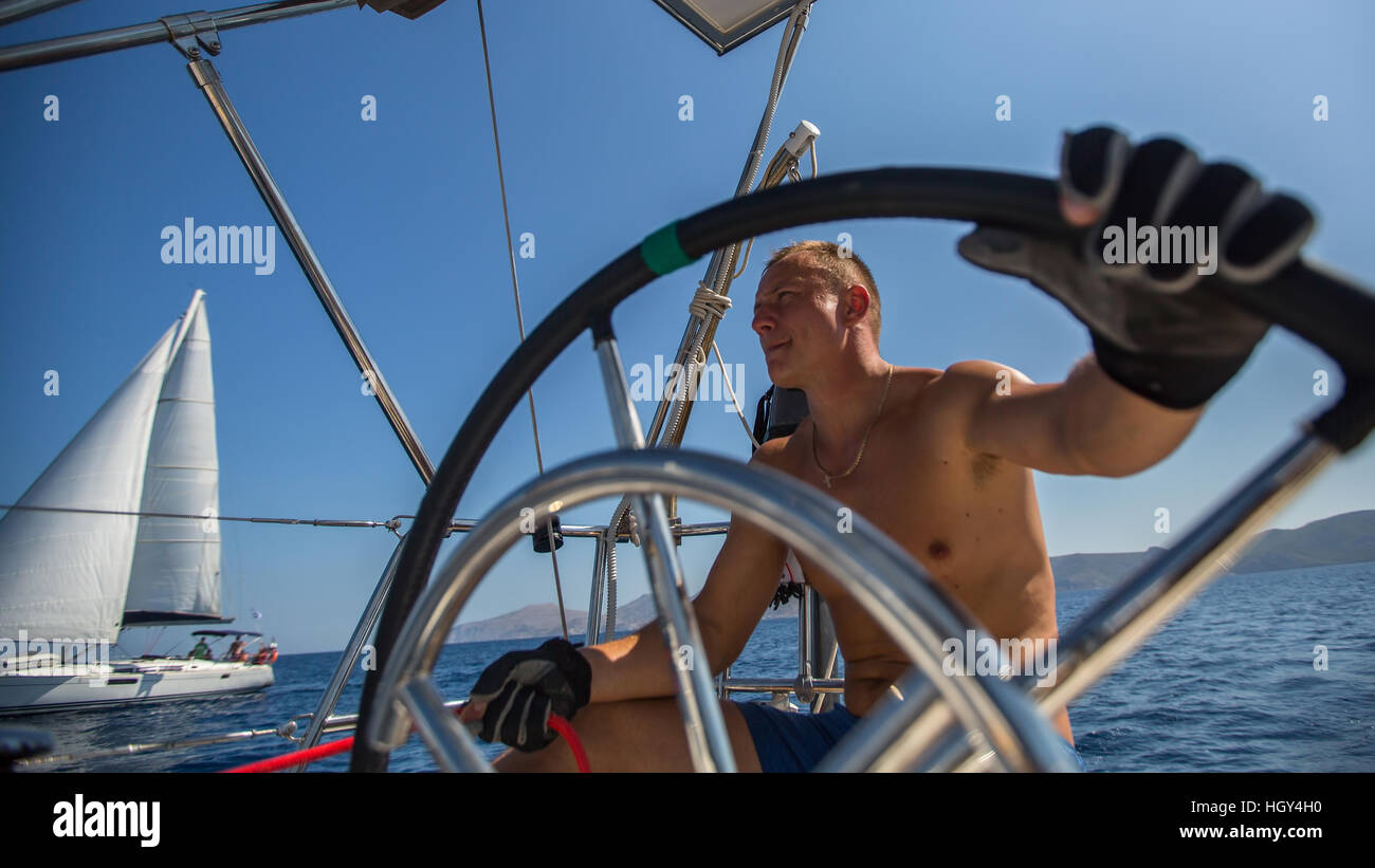 Young Man Skipper Steering Wheel During Sea Yacht Race Sailing Holidays And Travel Stock Photo Alamy