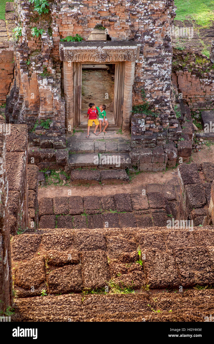 Two young Cambodian boys play among the ruins of Pre Rup, a tenth-century Hindu temple near Angkor, Cambodia. Stock Photo