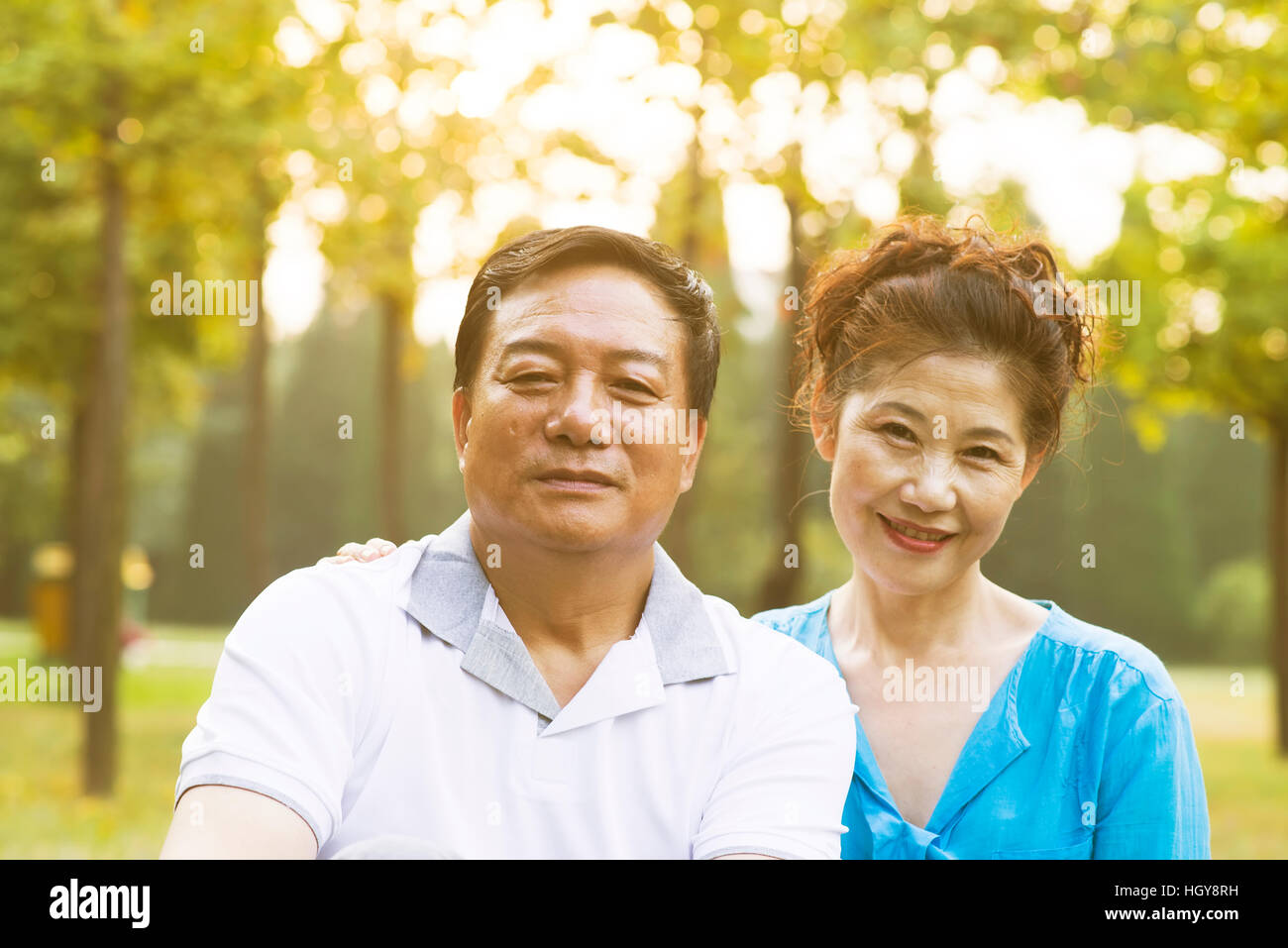 Happy old couple posing at autumn park Stock Photo