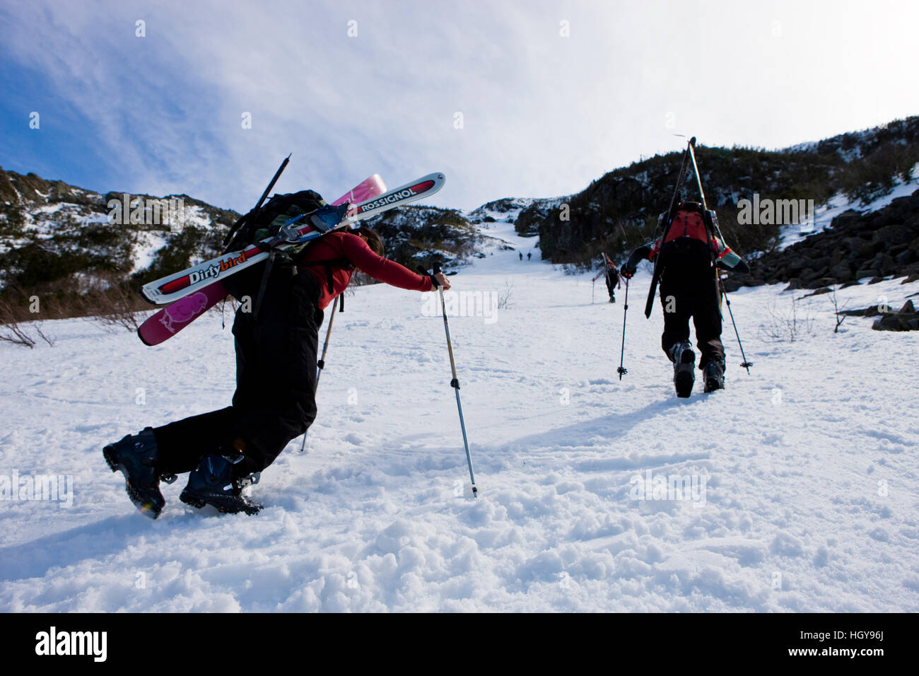 Telemark skiers climb the headwall of King Ravine in New Hampshire's