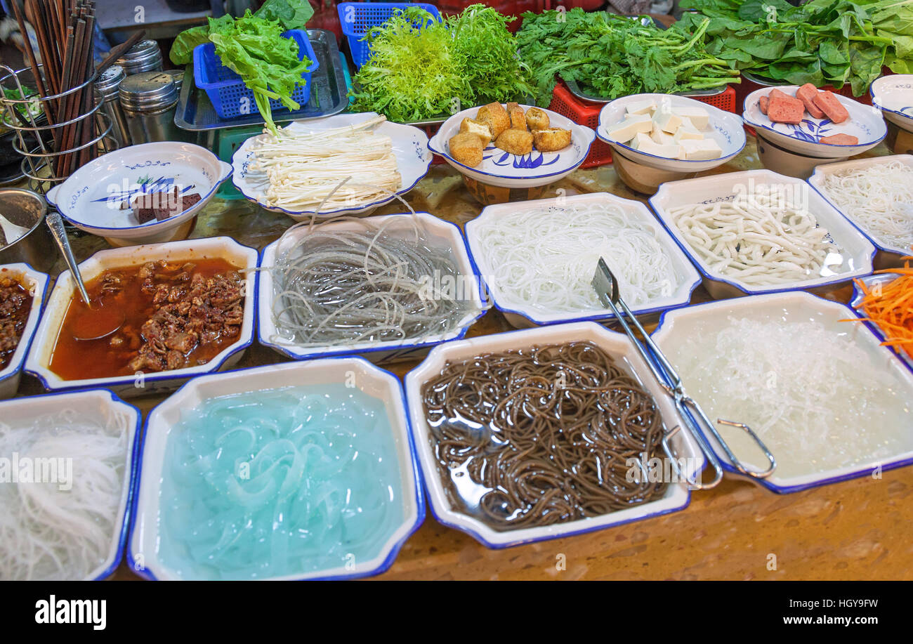 Variety of Chinese dishes at the market, Chinese street food concept. Stock Photo