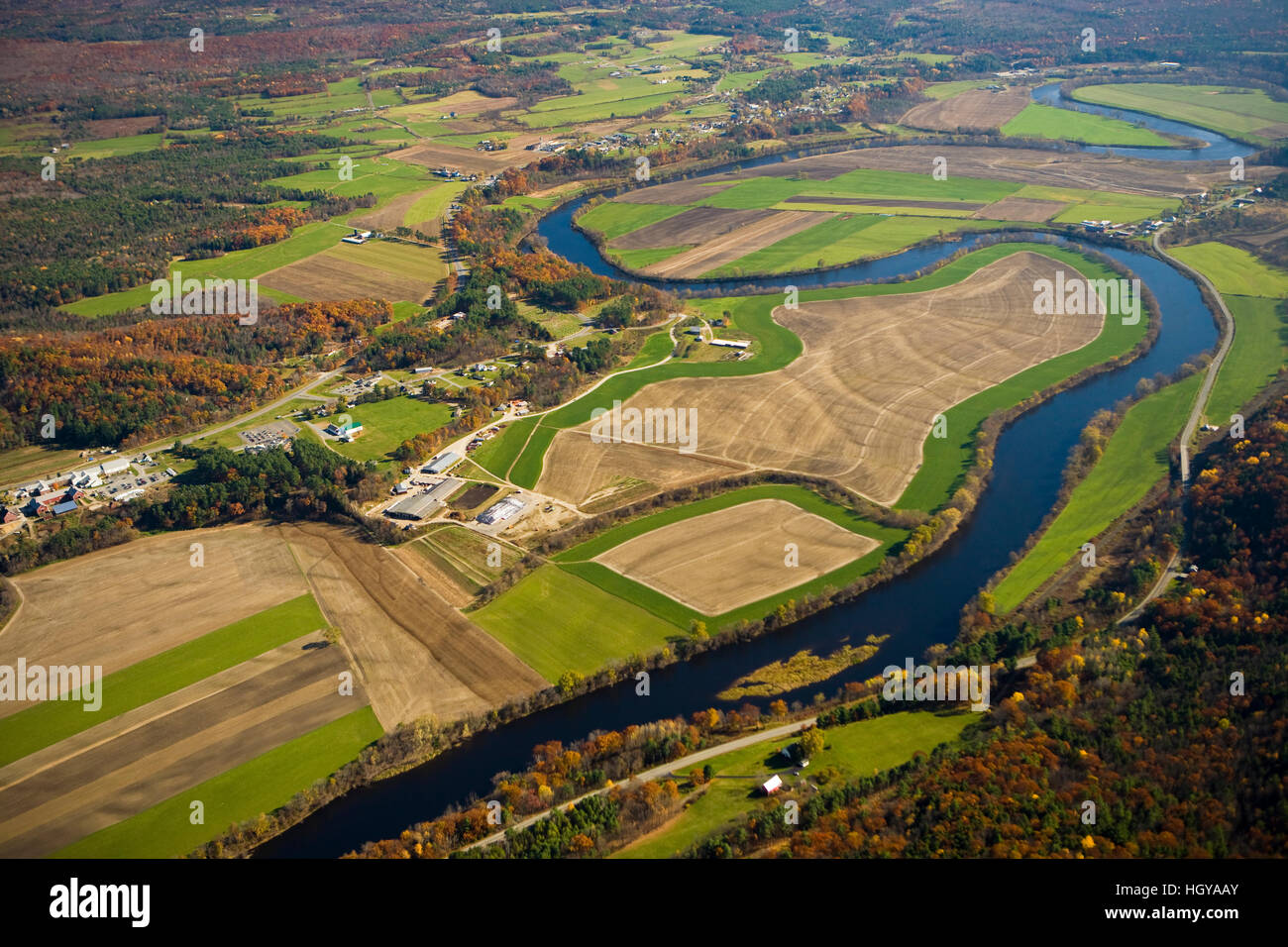 The Connecticut River flows through farmland in Newbury, Vermont and Haverhill, New Hampshire.  Aerial. Stock Photo