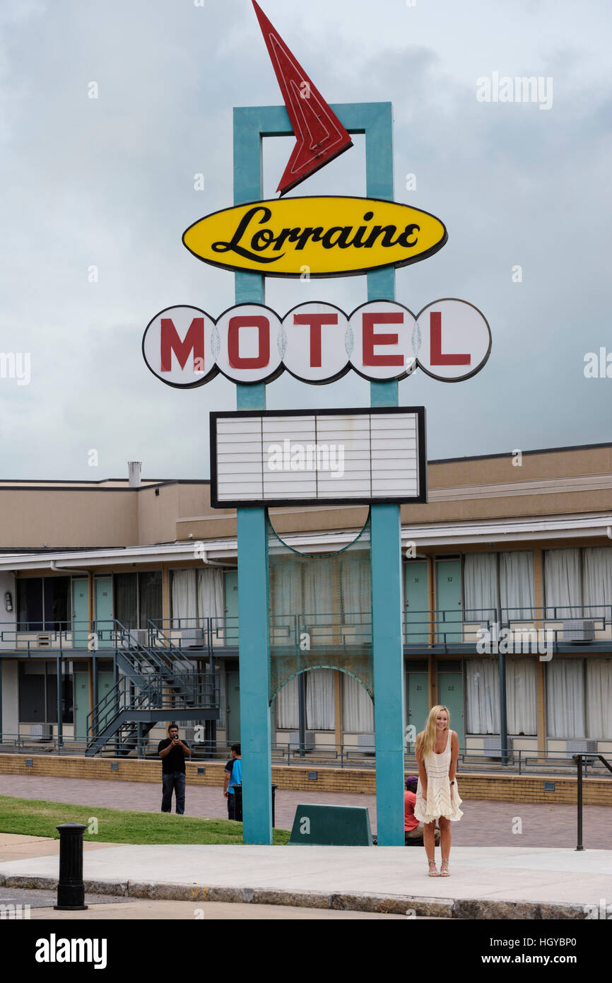 Young woman posing for a picture under the Lorraine motel neon sign, National Civil Rights Museum, Memphis, Tennessee, US Stock Photo