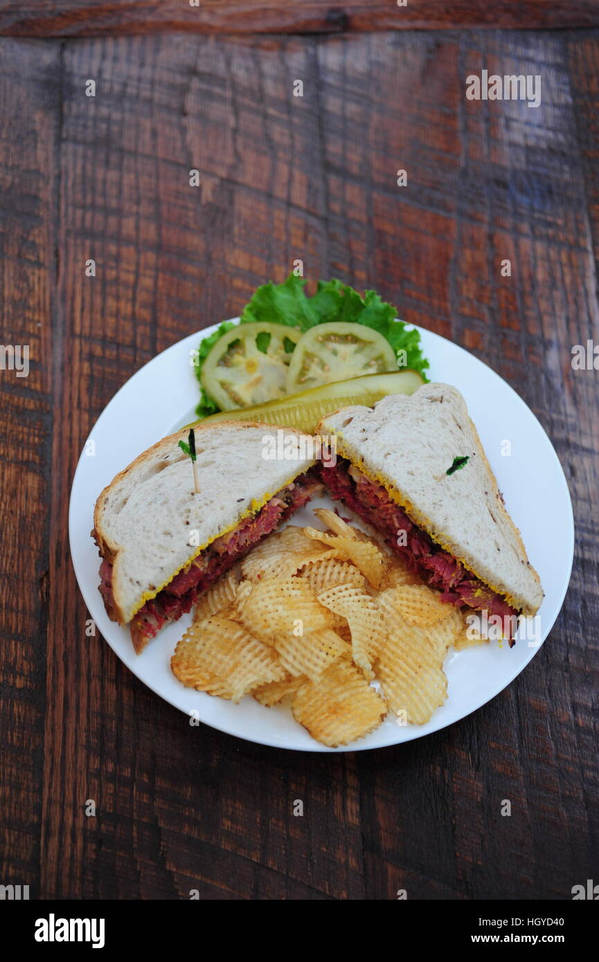 Corned beef on rye bread sandwich with potato chips Jewish deli