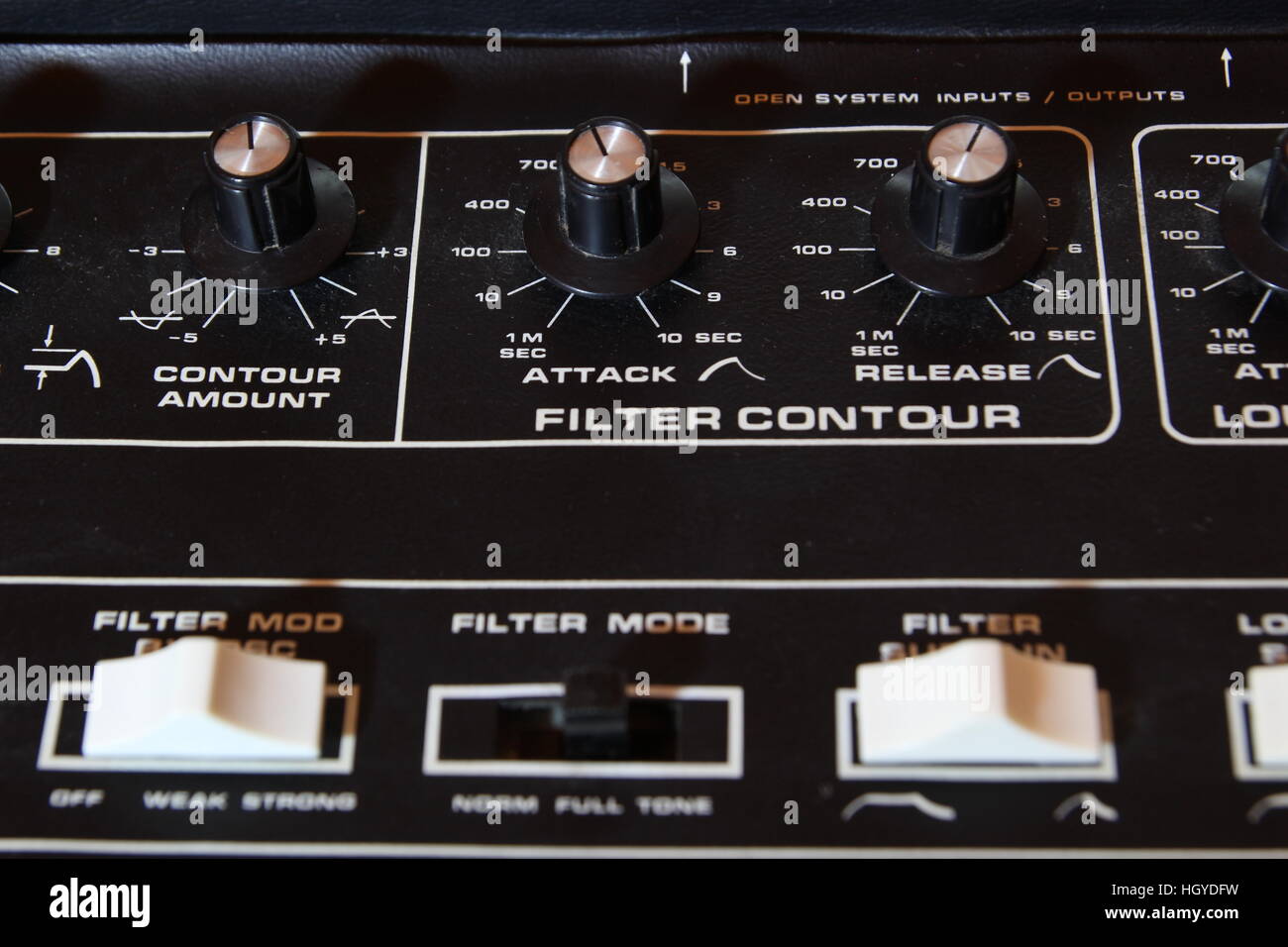 Vintage analogue music synthesizer control panel closeup in shallow