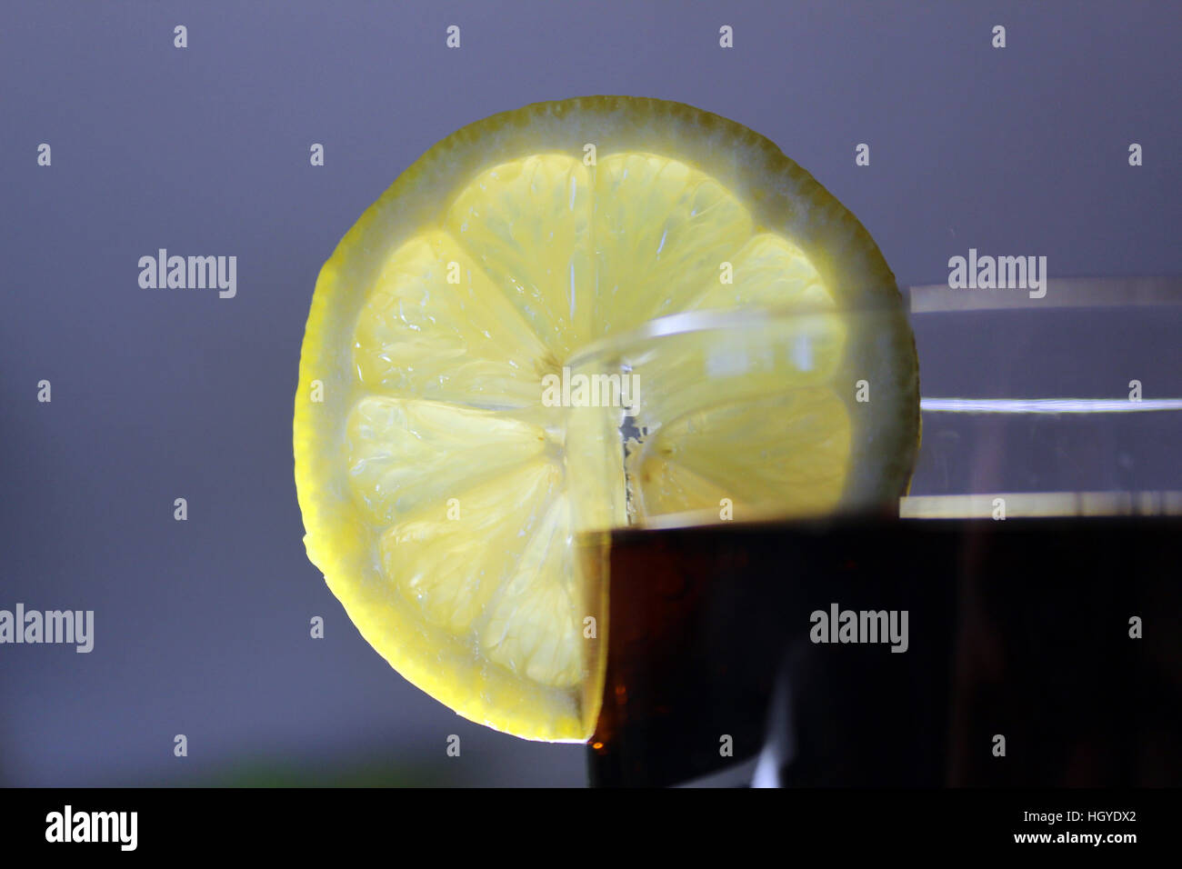 A glass full of cola decorated with lemon Stock Photo