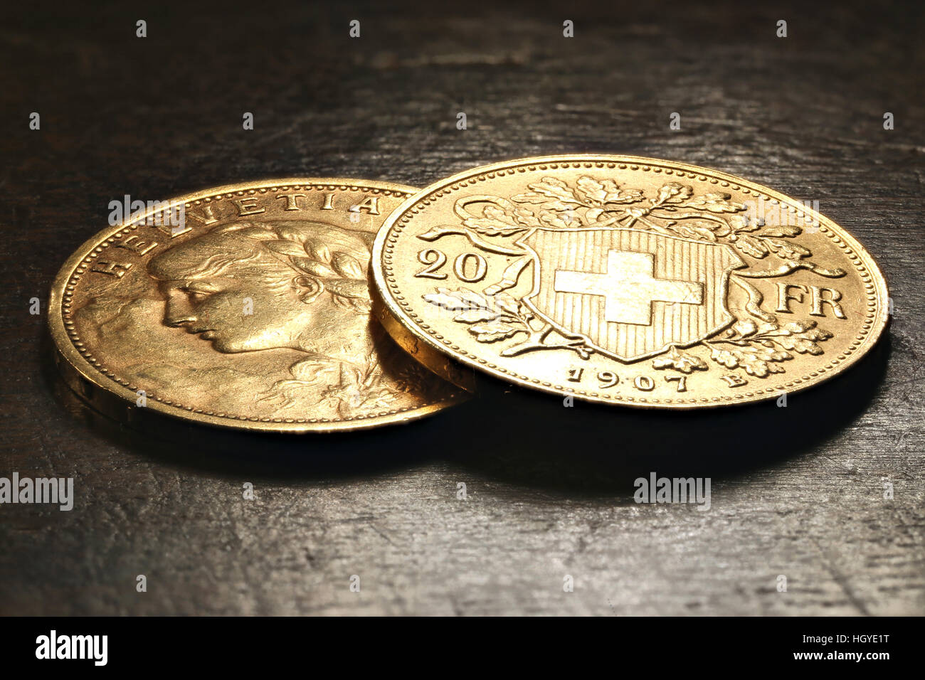 Swiss Vreneli gold coins on rustic wooden background Stock Photo