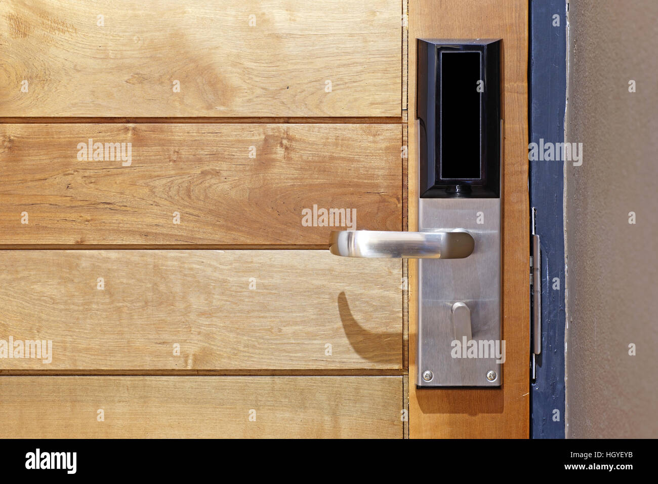hotel electronic card lock on wooden door Stock Photo