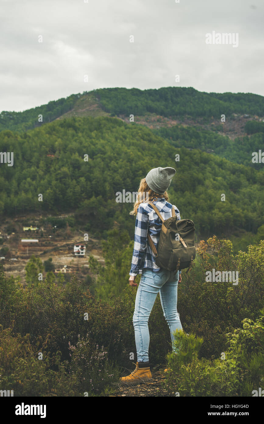 Young woman traveler hiking in the mountains, rear view Stock Photo - Alamy