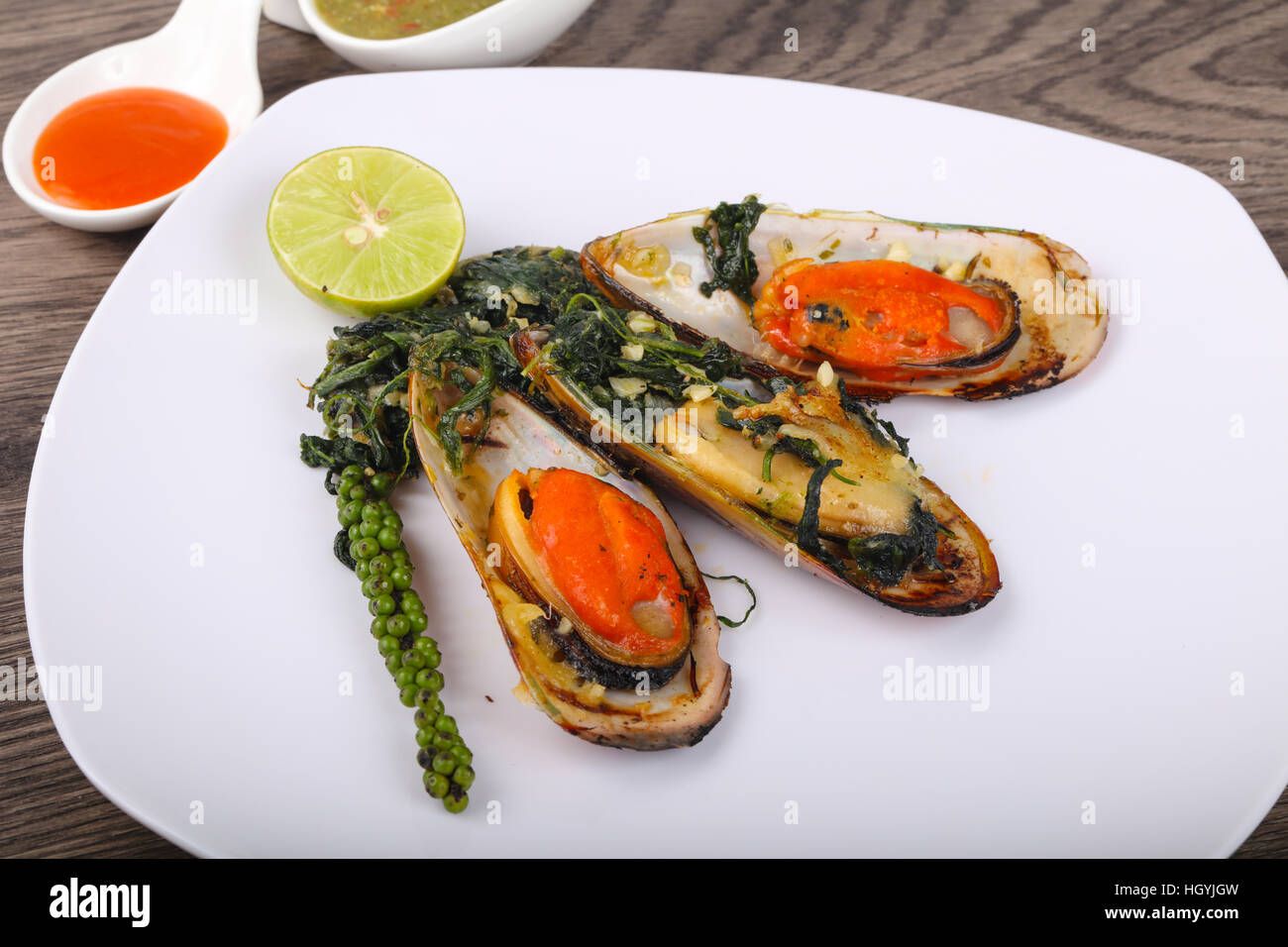 Baked mussels with spinach, lime and cheese Stock Photo Alamy