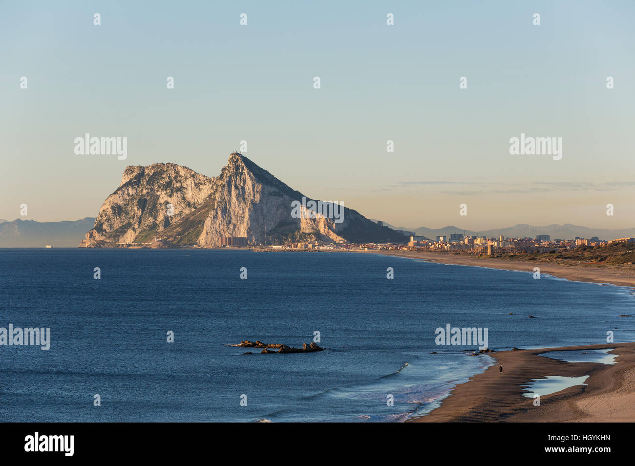 View of The Rock of Gibraltar and La Linea de la Concepcion as seen from the Mediterranean coast in the early morning light Stock Photo