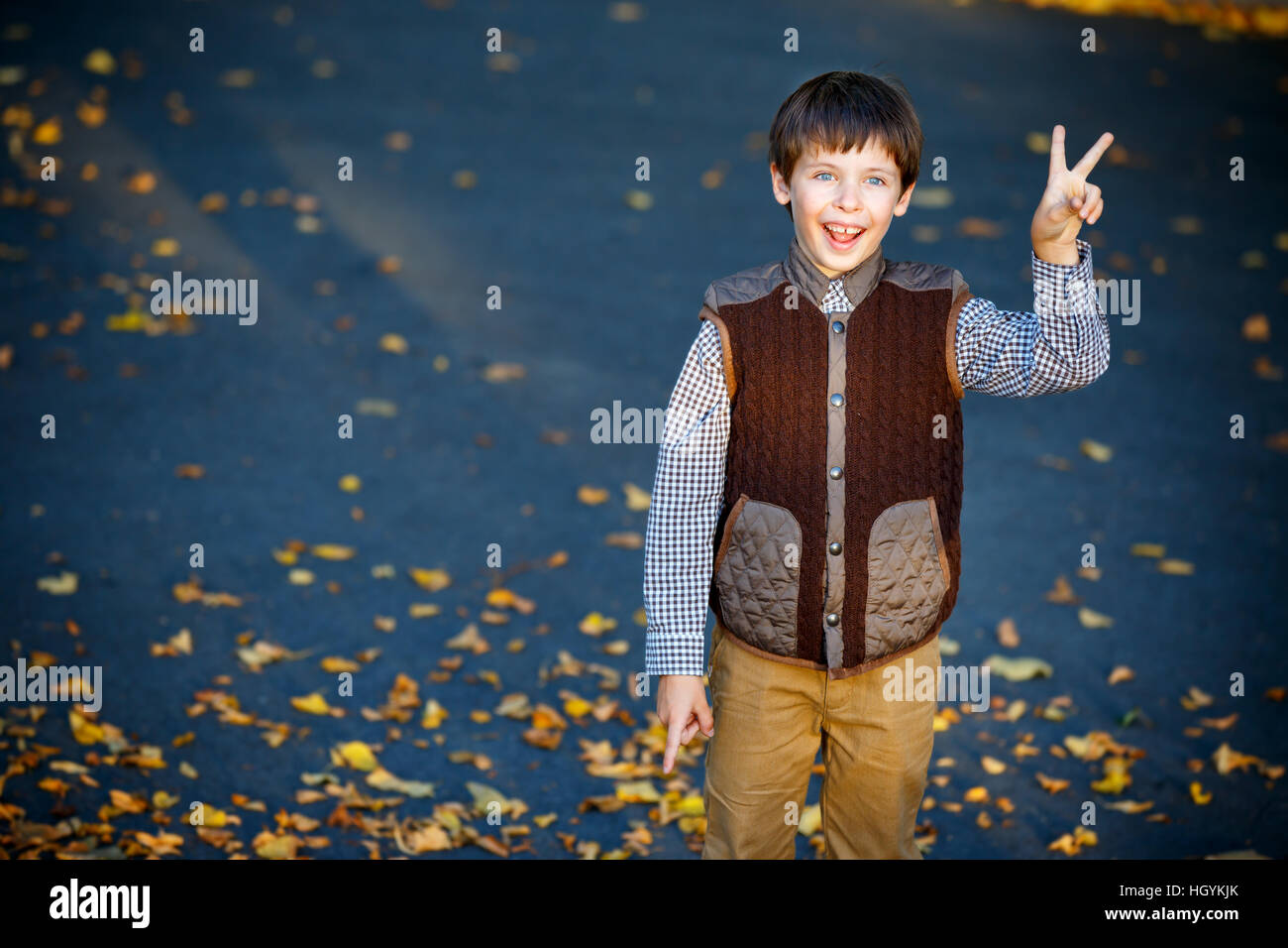Admiring little boy laughing outdoors Stock Photo