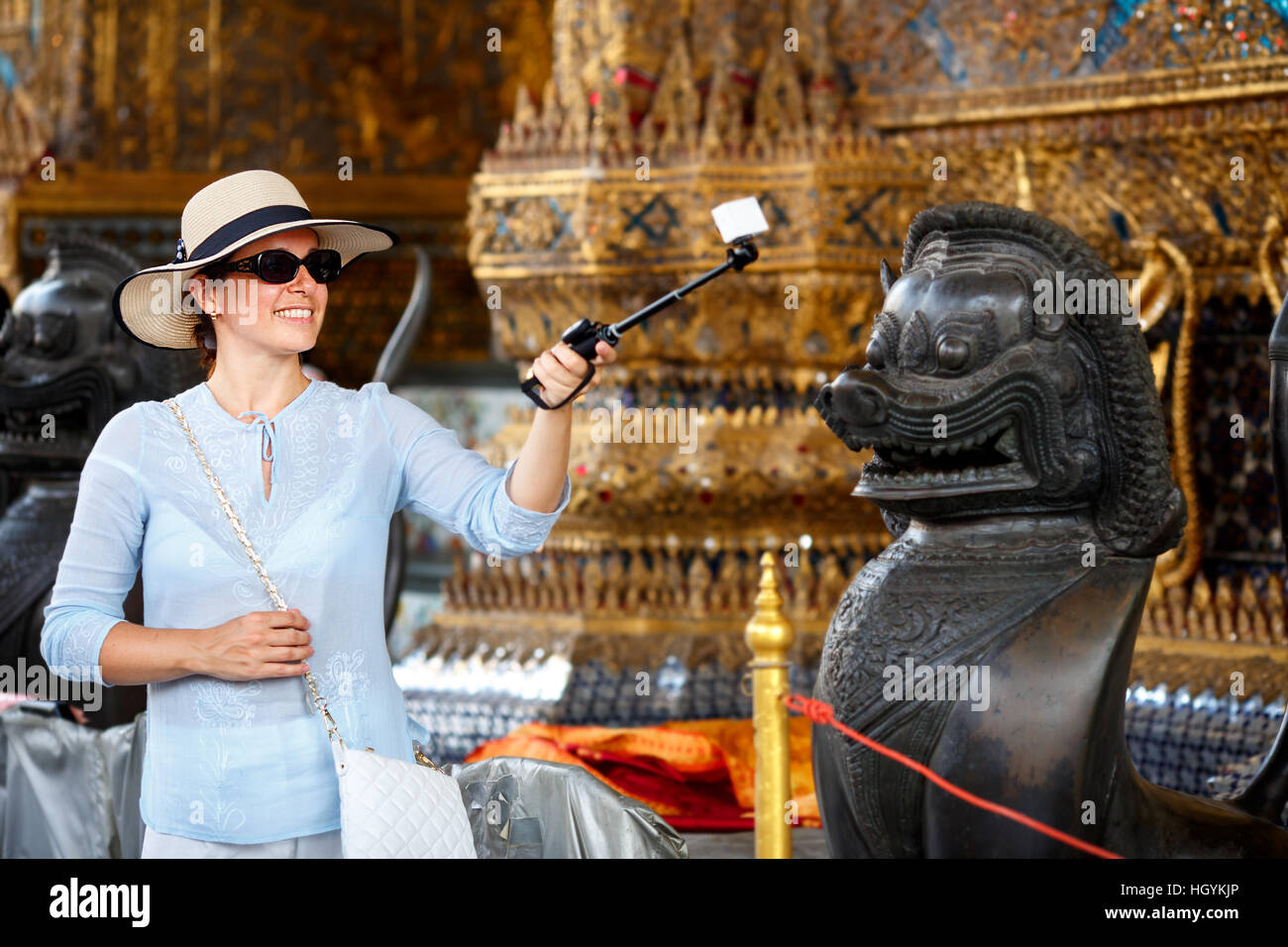 Young woman with hat and sunglasses making selfie, in Grand Palace Stock Photo