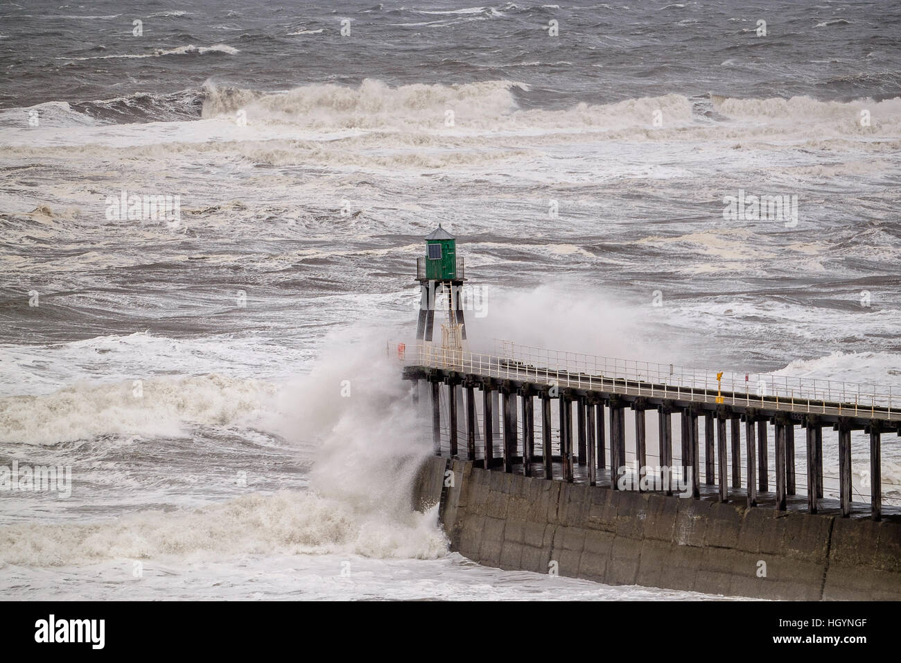 UK Weather. Whitby, North Yorkshire, UK. 13th January 2017. Rough seas breaking over protective piers around Whitby harbour caused by high winds in North-east England. Copyright Ian Wray Stock Photo