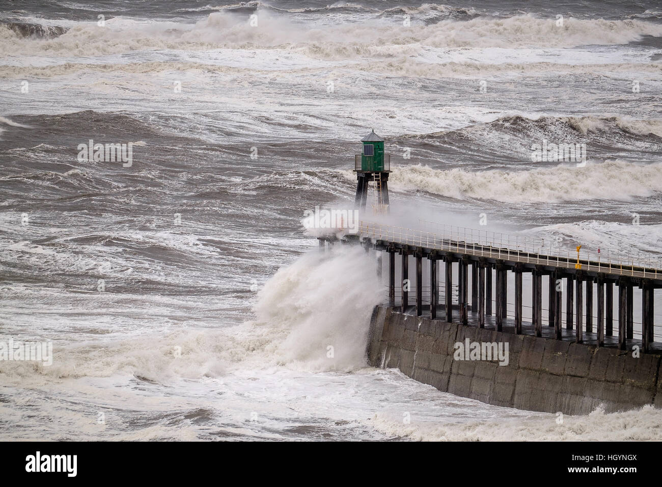UK Weather. Whitby, North Yorkshire, UK. 13th January 2017. Rough seas breaking over protective piers around Whitby harbour caused by high winds in North-east England. Copyright Ian Wray Stock Photo