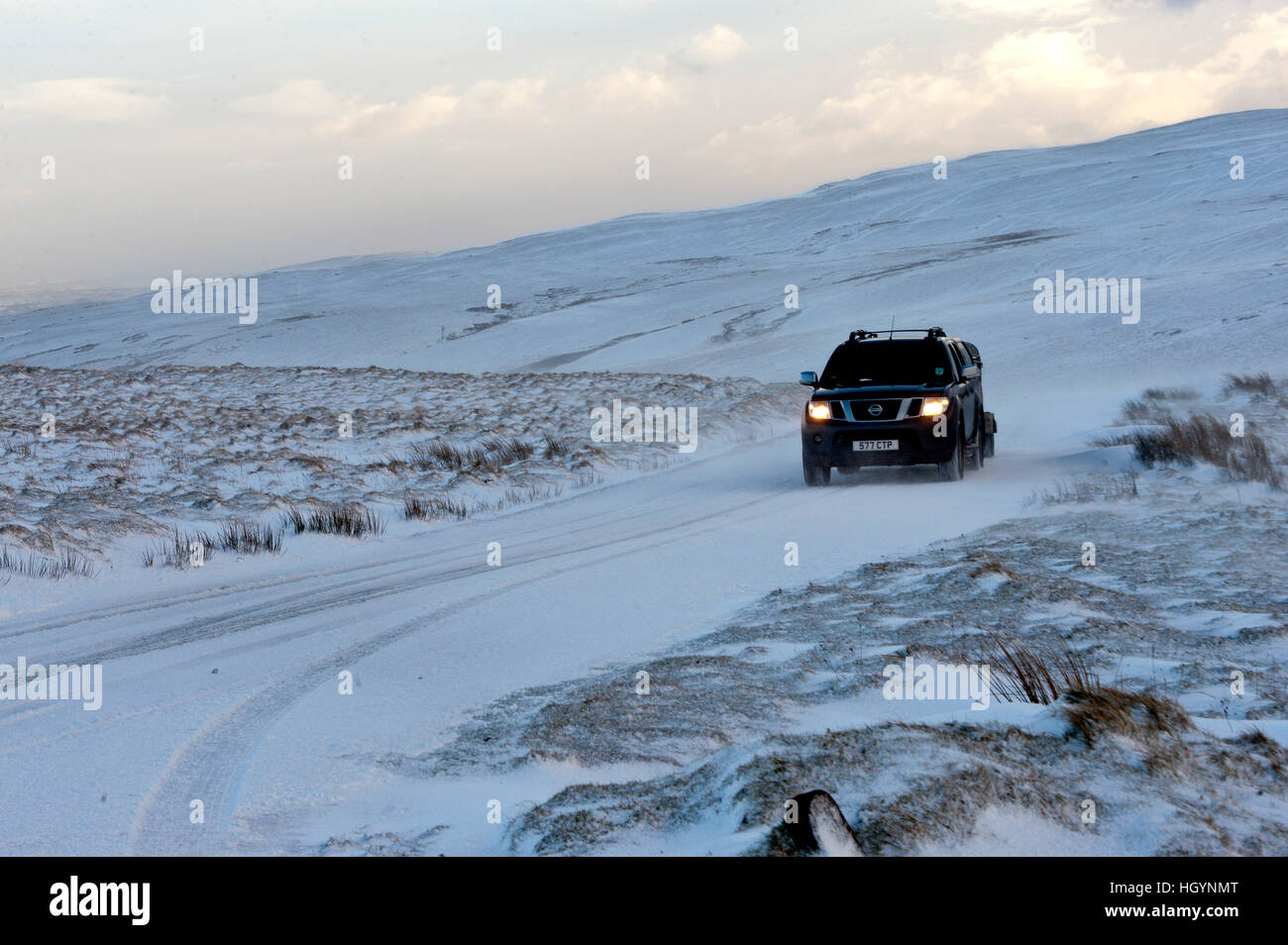 Elan Valley, Powys, Wales, UK. 13th January, 2017. Strong wind causes drifting of snow on the mountain road at Elan Valley in Powys, Wales, UK. © Graham M. Lawrence/Alamy Live News. Stock Photo