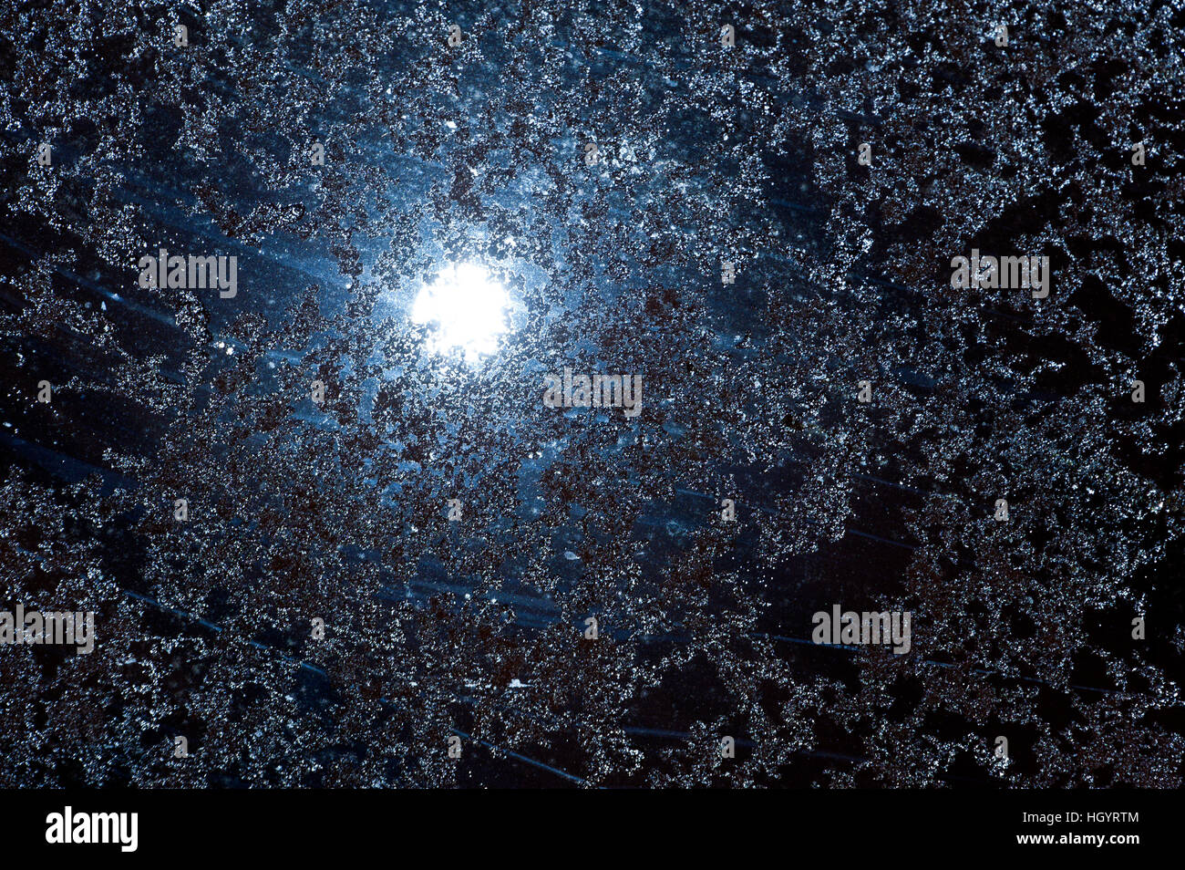Builth Wells, UK. 14th January, 2017. A waning gibbous Wolf Moon - the January moon also known as the Old Moon -  is seen just after midnight shining eerily through icy snowflakes on a roof skylight in Builth Wells, UK. © Graham M. Lawrence/Alamy Live News Stock Photo