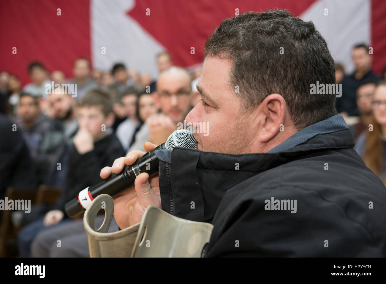 London, Ontario, Canada, 13th January, 2017. A recent Syrian refugee asks a question to the Prime Minister of Canada in London, Ontario, during a town hall Q&A. London was one of the Prime Minister's stops as part of his cross-country tour. Credit: Rubens Alarcon/Alamy Live News Stock Photo