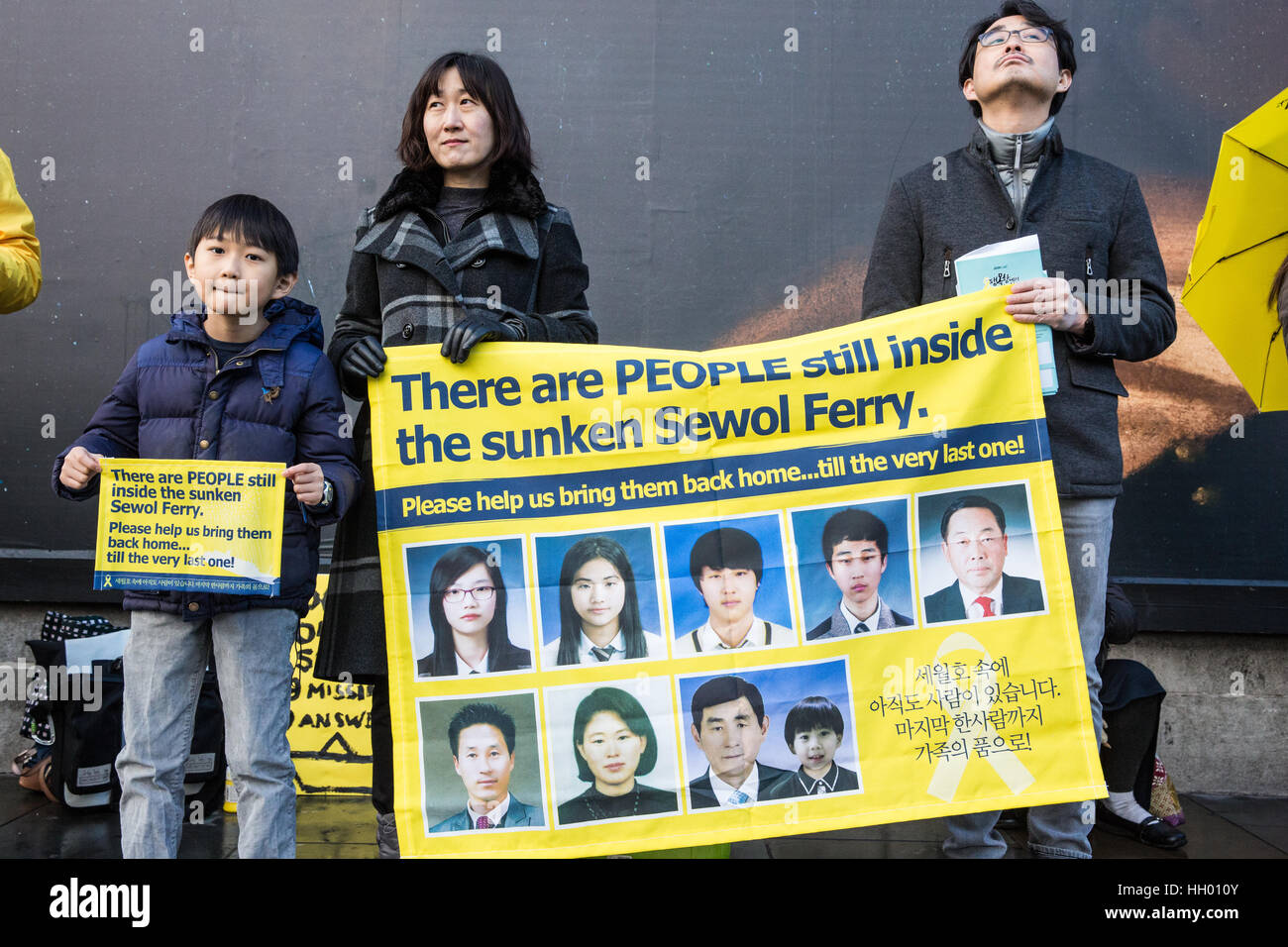 London, UK. 14th January, 2017. Members of the UK's Korean community hold a silent protest in Trafalgar Square to mark 1,000 days since the Sewol ferry disaster, to remember the victims and to demand that the Korean government not only raises the ferry without dismantling it to enable a thorough inquiry and recovery of all missing victims but also punishes those responsible and enacts anti-disaster regulations in London, UK. Credit: Mark Kerrison/Alamy Live News Stock Photo