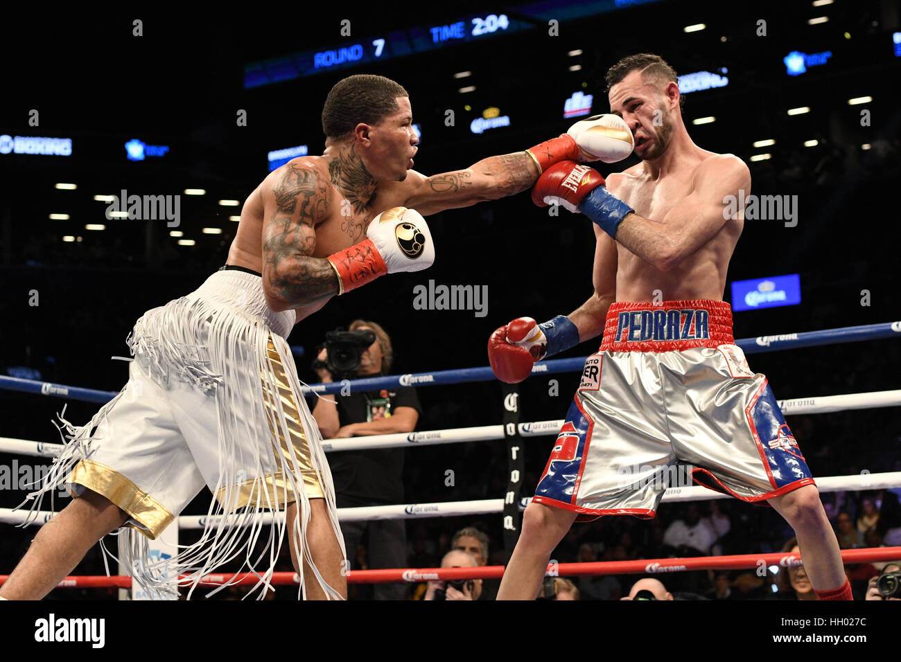 Brooklyn, New York, USA. 14th Jan, 2017. JOSE PEDRAZA (silver, red, and blue trunks) and GERVONTA DAVIS battle in a junior lightweight championship bout at the Barclays Center in Brooklyn, New York. Credit: Joel Plummer/ZUMA Wire/Alamy Live News Stock Photo