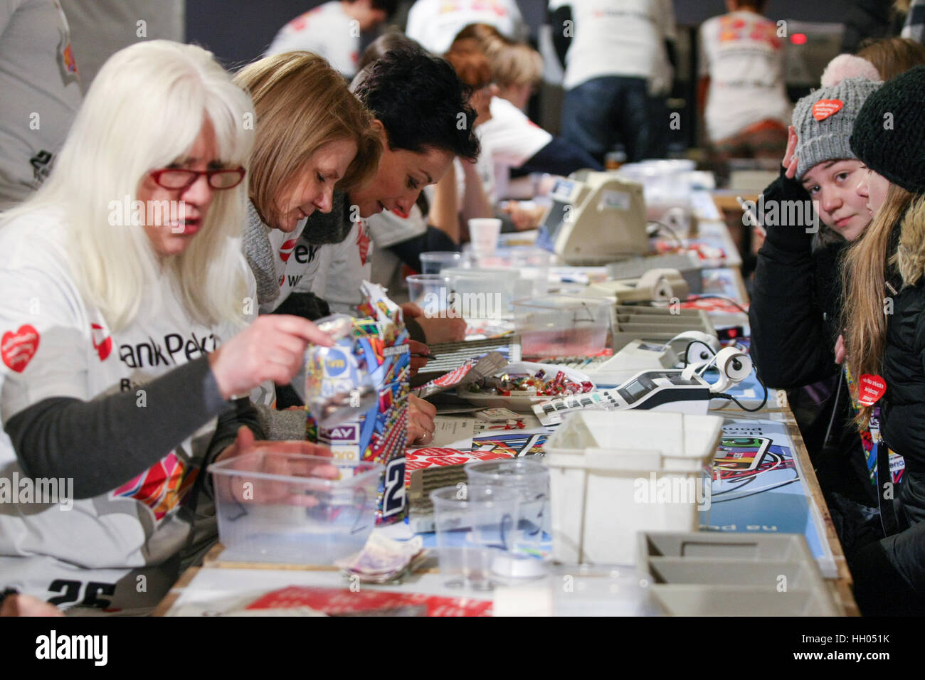 Gdansk, Poland. 15th January 2017. Volunteers counting the collected  money are seen during 25th Grand Finale of Great Orchestra of Christmas Charity (WOSP) on January 15th, 2017 in Gdansk. Over 120 thousands of volunteers across the Poland collect money on the streets in special cans labelled with a red heart. This year finale is once again devoted to paediatrics and geriatrics. Credit: Michal Fludra/Alamy Live News Stock Photo