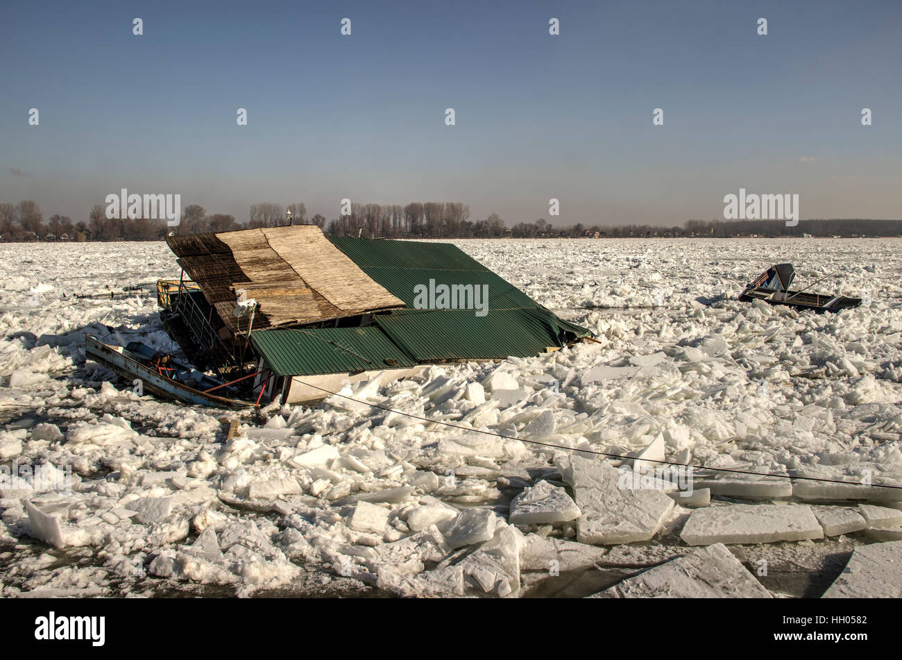 Ice chunks float on the Danube destroying everything in their path. Blocks of ice crushed dozens of raft houses and boats. Stock Photo