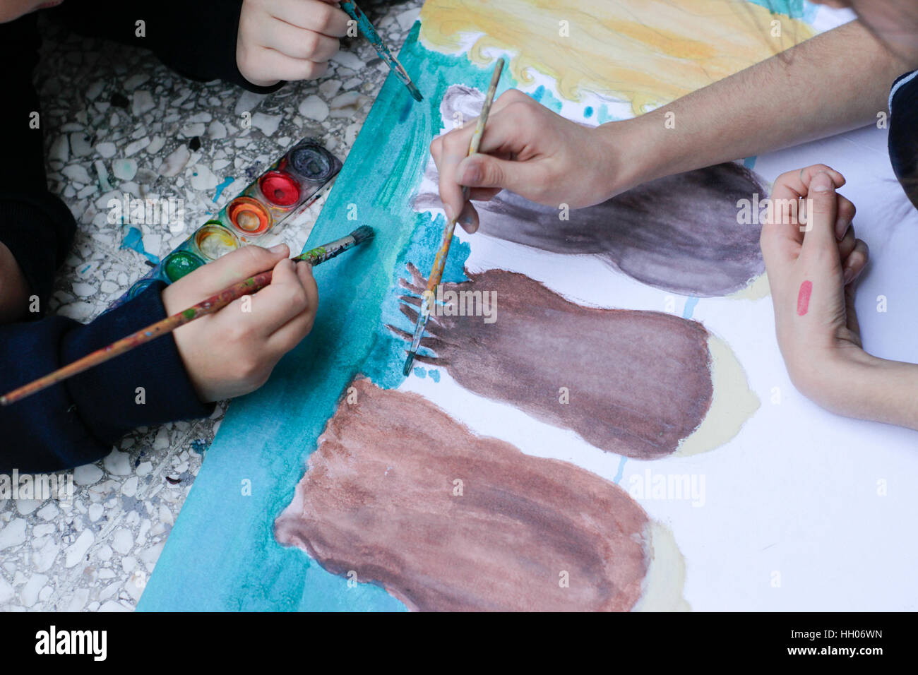 Photograph of some children painting with watercolor Stock Photo - Alamy