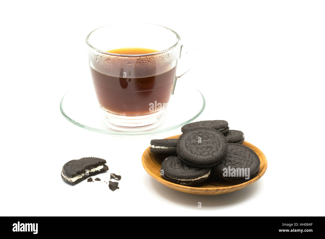 Chocolate cookies in wooden plate with a cup of coffee on white background Stock Photo