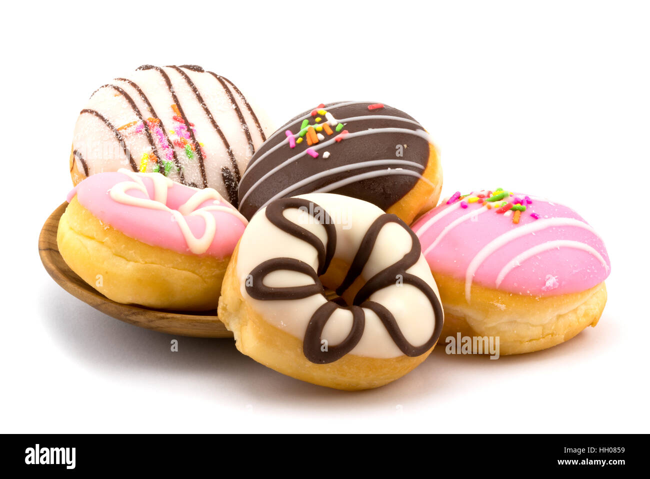 Tasty homemade doughnuts in a wooden plate on white background Stock Photo