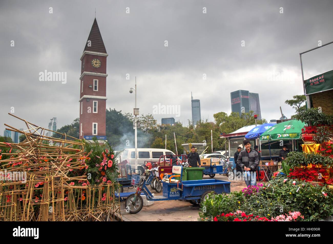 This is a moody picture of the beautiful Shenzhen Flower Trade Market  with the clock tower in the background.  Shenzhen, China Stock Photo