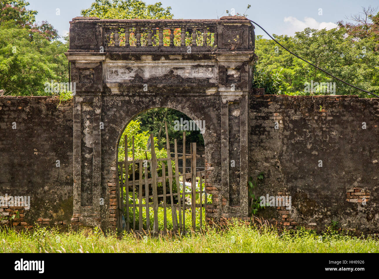 The ruins of an old weathered entrance gate in the walled Citadel and Imperial Palace in Hue.  Its is a UNESCO World Heritage. Stock Photo
