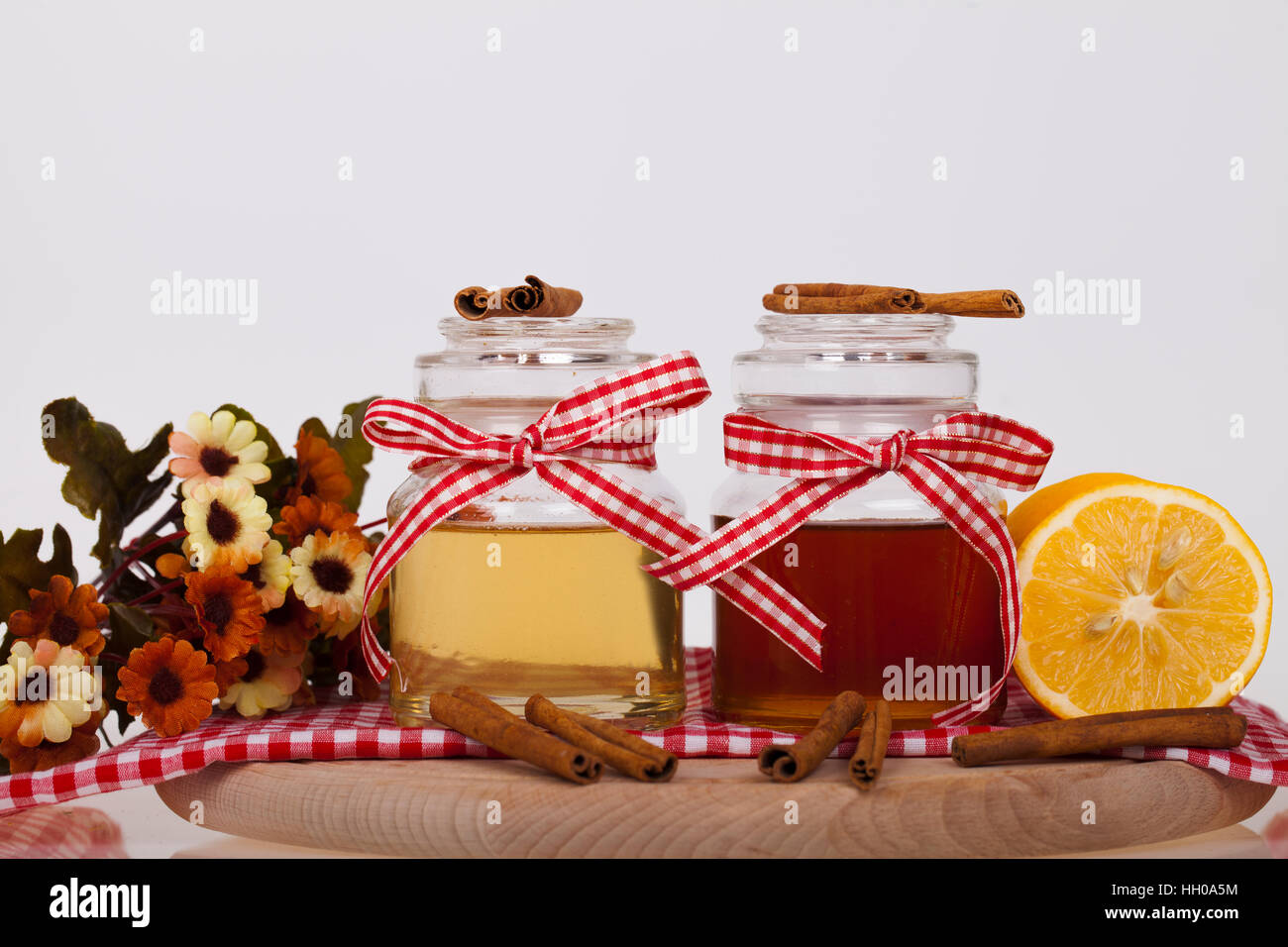 Honey in  jar with honey dipper on a wooden background Stock Photo