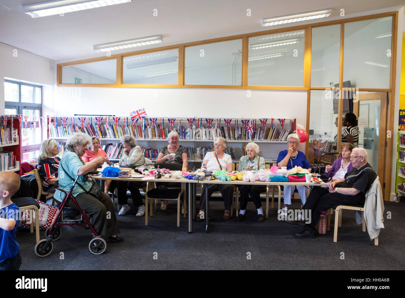 Elderly women selling knitwear during a party celebrating the Queen Elizabeth II's Birthday at Barking Community Centre Stock Photo