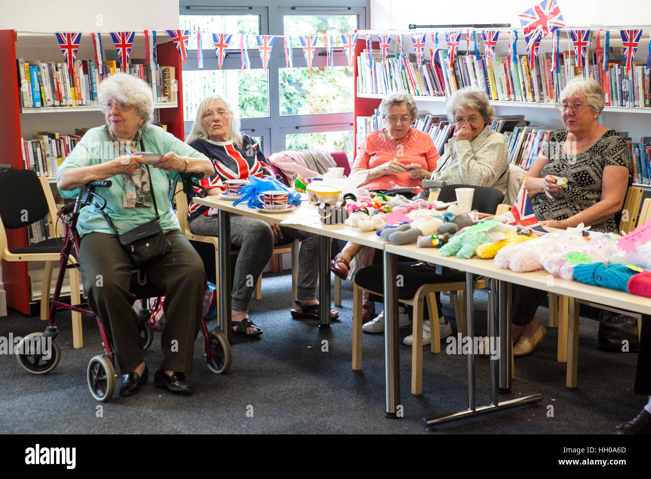 Elderly women selling knitwear during a party celebrating the Queen Elizabeth II's Birthday at Barking Community Centre . Stock Photo
