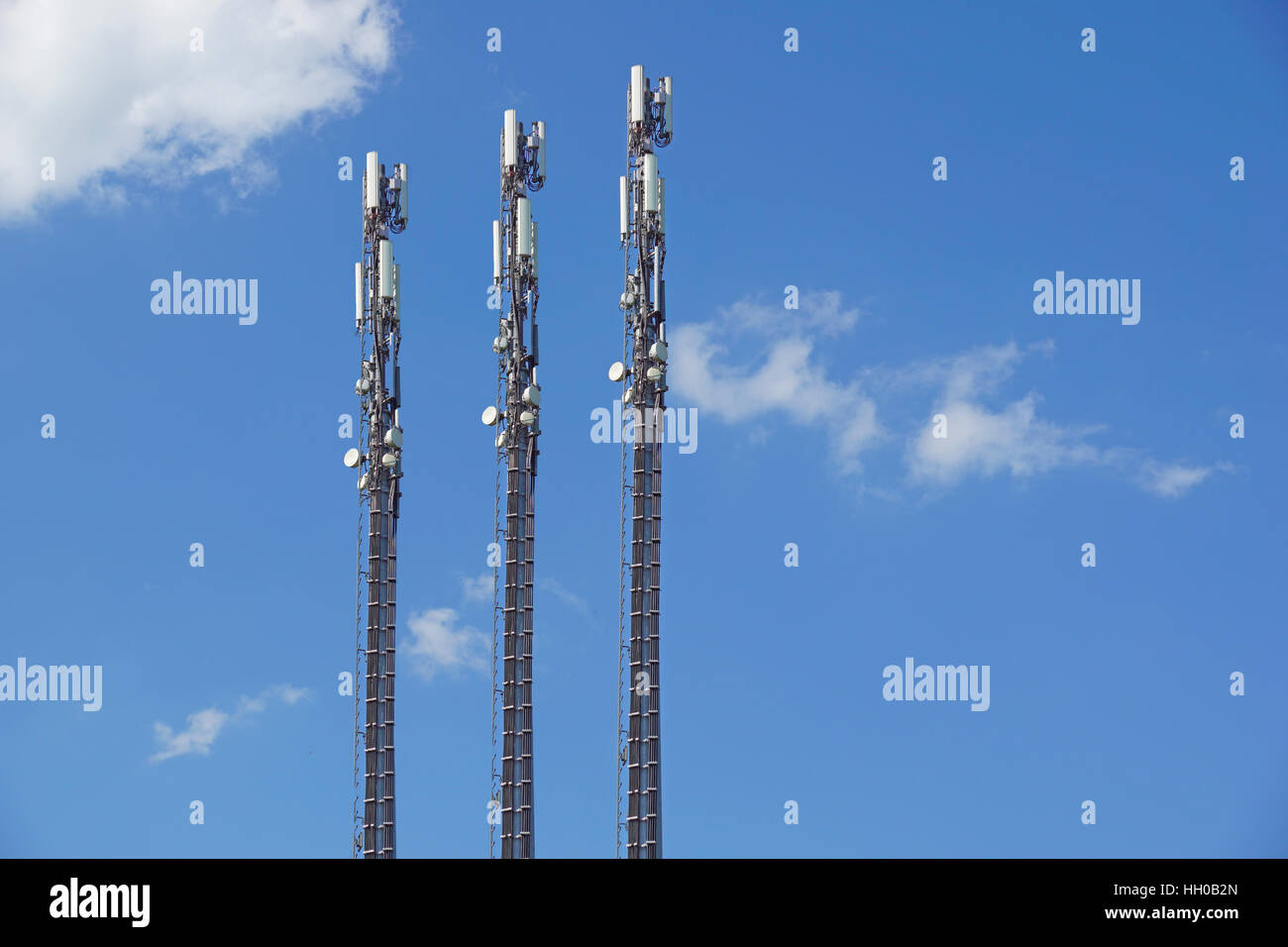 structure tower of cell phone antenna with blue sky Stock Photo