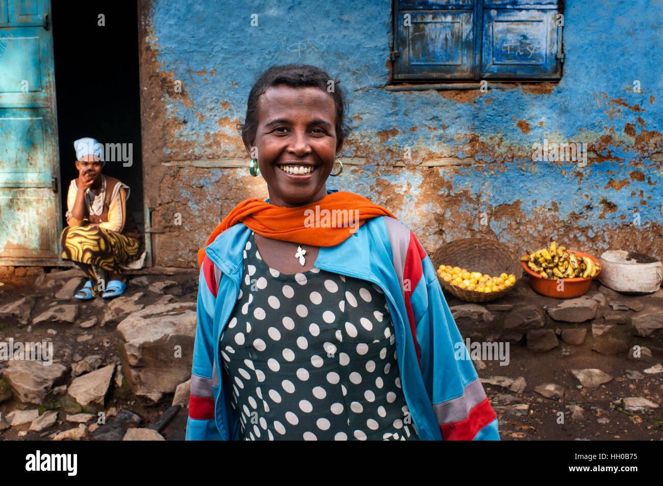 Woman outside of one of the oldest houses in the city of Gondar, Ethiopia. Gondar Imperial city filled with castles of the ancient emperors, also in a Stock Photo