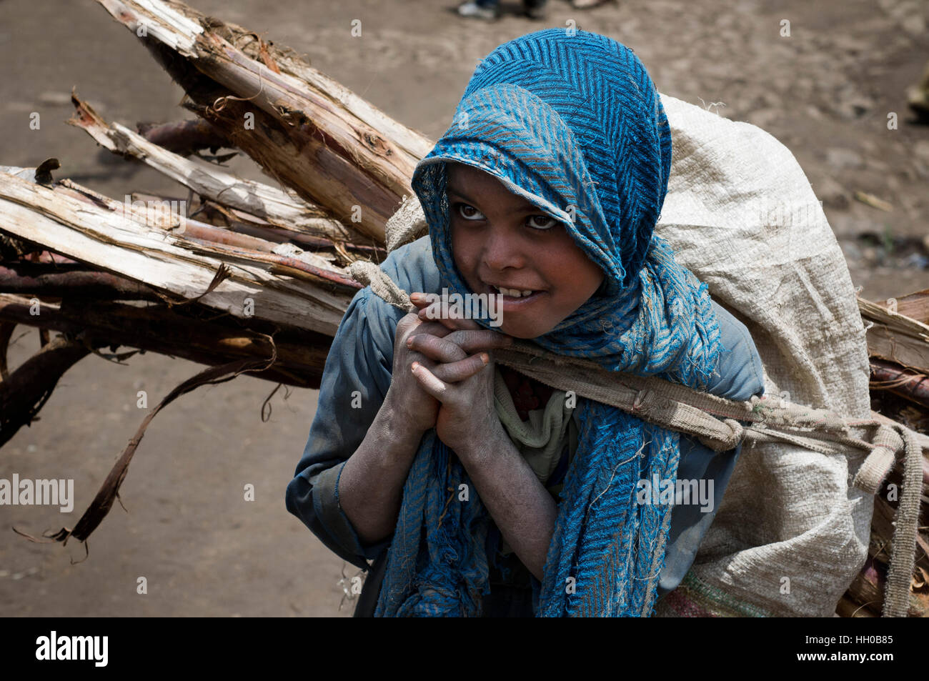 Market place. Debark. Simien Mountains. Northern Ethiopia. A girl loaded up with firewood at the Debark market. Debark has a few shops and stalls wher Stock Photo