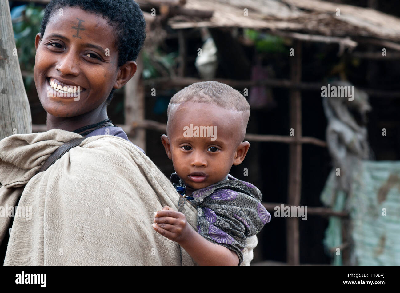 Hawzen town, Eastern Tigray, Ethiopia. Ethiopian mothers carry their children all day in this kind of baby carrier. Sometimes the simplest things turn Stock Photo