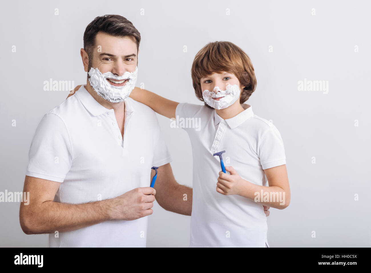 Positive delighted males holding razors Stock Photo Alamy