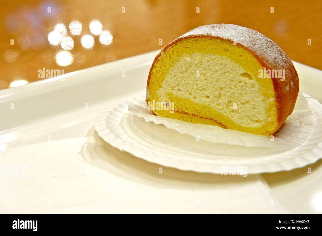 Creamy swiss roll on a white dish Stock Photo