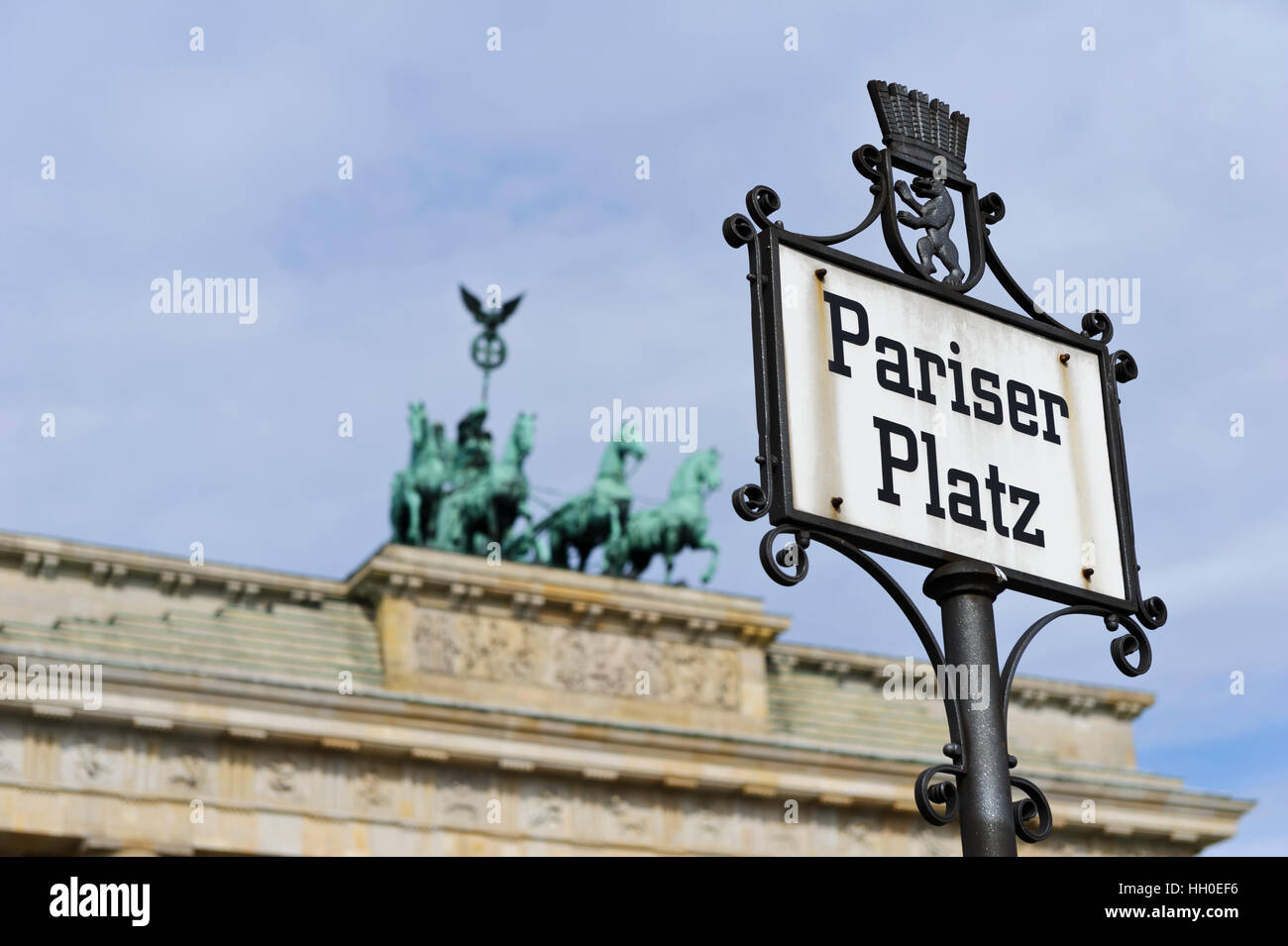 A road sign in front of the iconic Brandenburg Gate with a chariot and ...