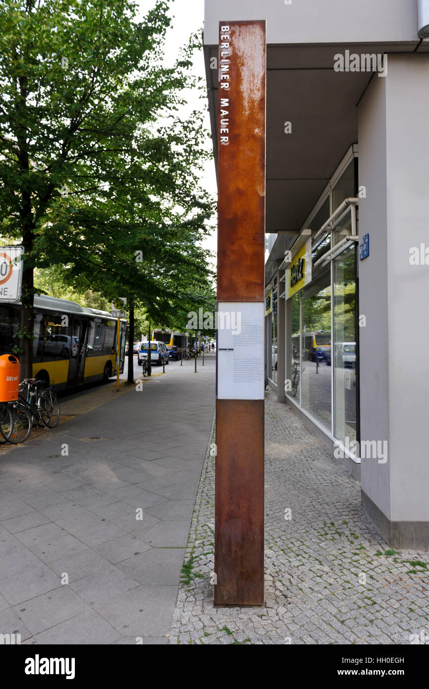 A steel pole marks the location of the former wall that separated West and East Berlin during the Cold War. Stock Photo