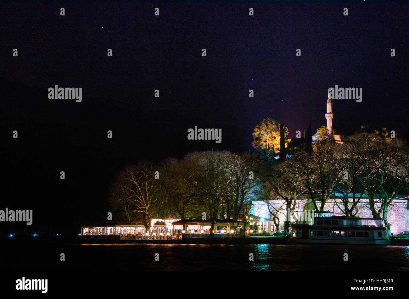 Ioannina city in Greece. View of the lake and the mosque of Aslan Pasa cami at night. Stock Photo