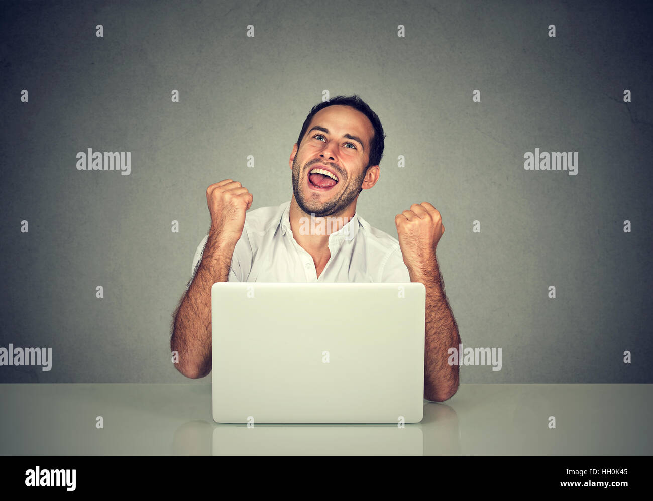 Happy business man achieving his goal and pumping fists celebrating success Stock Photo