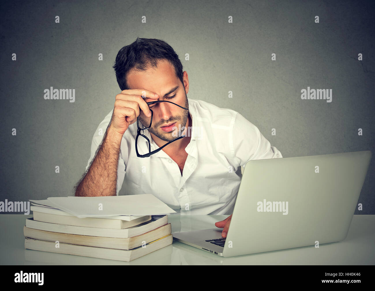 Too Much Work Tired Sleepy Man Sitting At Desk With Books In Front